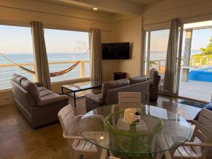 a living room with a view of the ocean at Tranquility Bay Beach Retreat in Trujillo
