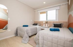 a bedroom with two beds and a window at Luxury3BRLagoonView Beach BBQ in San Bernardino