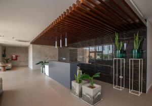 a kitchen with potted plants on the wall at Luxury3BRLagoonView Beach BBQ in San Bernardino
