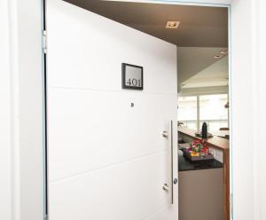 a room with white walls and a door with a clock on it at Luxury3BRLagoonView Beach BBQ in San Bernardino +39 photos