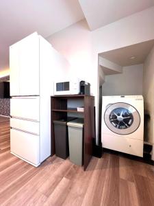 a laundry room with a washing machine and a washer at The Lobs Five, Brand New, 4 bedroom, 3 bath, 4 toilet, 8 min to Rusutsu, 7-11, bus at door in Kimobetsu +17 photos