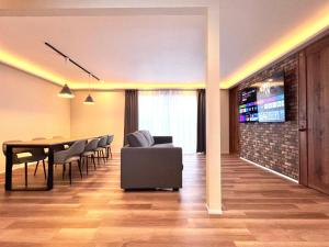 a living room with a dining room table and chairs at The Lobs Five, Brand New, 4 bedroom, 3 bath, 4 toilet, 8 min to Rusutsu, 7-11, bus at door in Kimobetsu