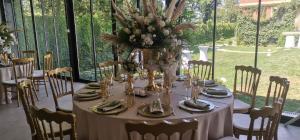 a table with a vase of flowers on it at The Belgrade Hills Rooms and Suites in Belgrade +43 photos