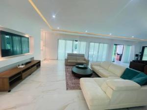 a large living room with a couch and a table at villa zoum in Assinie