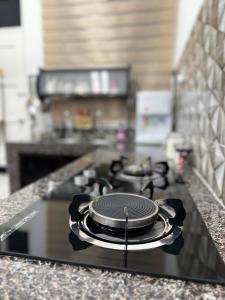 a stove top with a pot on it in a kitchen at NY VILLA Homestay in Kota Bharu