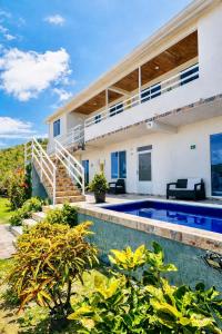 a villa with a swimming pool and a house at Posada Lkjay Providencia Isla in Providencia +46 photos