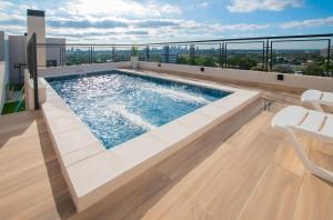 a swimming pool on the roof of a building at Comfy Apt w Pool & Coworking in Fernando de la Mora