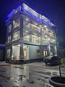 a large white building with a car parked in a parking lot at Mộc View House in Mộc Châu
