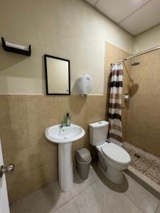 a bathroom with a toilet and a sink at Ducky 1 in San Miguel