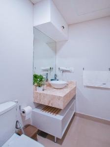 a bathroom with a sink and a mirror at Cozy 1BR Desk Pool & Terrace in Fernando de la Mora