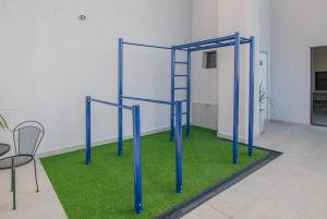 a blue frame in a room with green grass at Cozy 1BR Desk Pool & Terrace in Fernando de la Mora