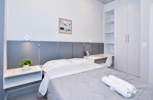 a white bedroom with a large bed and a desk at Cozy 1BR Desk Pool & Terrace in Fernando de la Mora