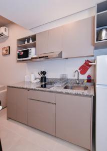 a kitchen with white cabinets and a sink at Cozy Apt Pool CoWorking U116 in Fernando de la Mora
