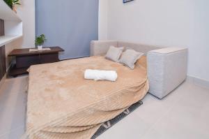 a bedroom with a large bed with a pillow on it at Cozy Apt Pool CoWorking U116 in Fernando de la Mora +11 photos