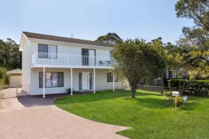 an image of a house with a yard at Callala On King - Pet Friendly - Swimming Pool in Callala Beach