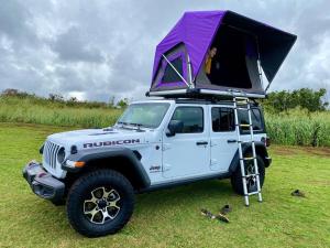 a white jeep with a tent on top of it at Island Breeze Rooftop Camper fully equipped rubicon in Anahola