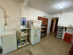 a kitchen with two white refrigerators in a room at El Barquero in Puerto Baquerizo Moreno
