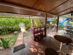 a covered patio with a table and an umbrella at El Barquero in Puerto Baquerizo Moreno