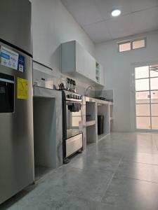 a large kitchen with stainless steel appliances in a room at Hammerhead Shark Apartment in Puerto Baquerizo Moreno