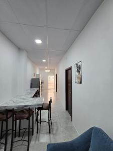 a dining room with a long table and chairs at Hammerhead Shark Apartment in Puerto Baquerizo Moreno