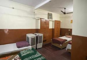 a room with two beds and twounks in a room at Shivangi hotel in Bareilly +11 photos