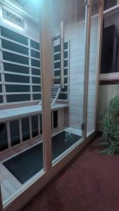 a room with two glass doors with a window at Ranfurly Hostel with Sauna in Ranfurly