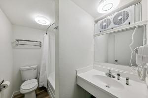 a white bathroom with a sink and a toilet at Ambassador Lake Tahoe in South Lake Tahoe