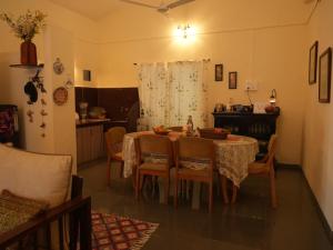 a dining room with a table and some chairs at Alhaad valley views in Mulshi