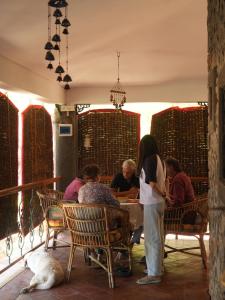 a group of people sitting at a table in a restaurant at Alhaad valley views in Mulshi