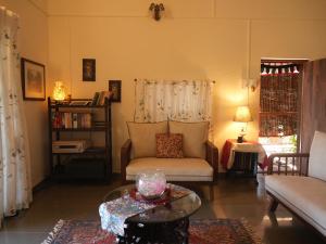 a living room with a couch and a table at Alhaad valley views in Mulshi