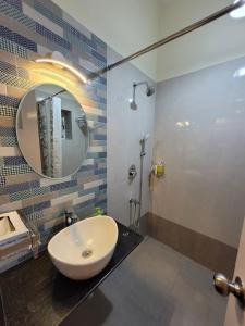 a bathroom with a sink and a mirror at Alhaad valley views in Mulshi +64 photos