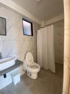 a bathroom with a toilet and a sink and a shower at Casa Artesana Maras URU CUZ PE in Maras