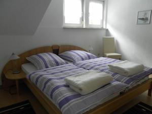 a bed with two pillows on top of it at Burgblick Rech - Ahrtal in Rech
