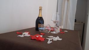 a bottle of wine and wine glasses on a table at Dimora Dei Gelsi in Polignano a Mare