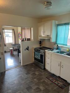a kitchen with a sink and a stove top oven at Lakeside Dune Getaway in Lakeside
