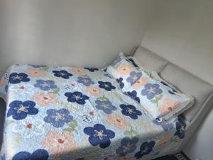 a bed with two pillows on top of it at SHA HOMESTAY Budget in Tampin