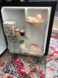 an open refrigerator filled with eggs and milk at Fantail at Bluestone Retreat in Leeston