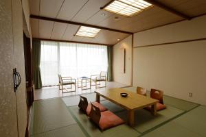 a room with a table and chairs and a dining room at Villa Inawashiro in Inawashiro