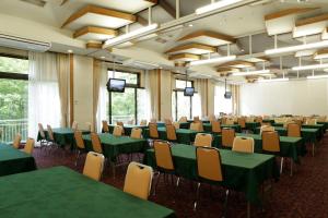 a conference room with green tables and chairs at Villa Inawashiro in Inawashiro