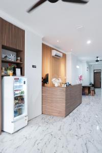 a kitchen with a counter and a refrigerator at Aurora House Surabaya in Wijung