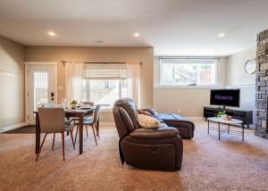 a living room with a couch and a table and chairs at Serenity suite in Lethbridge