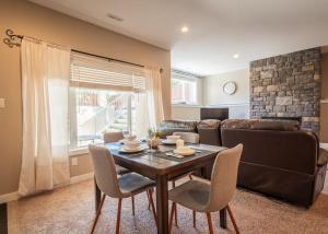 a living room with a table and a couch at Serenity suite in Lethbridge