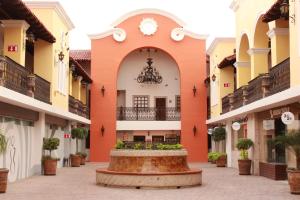 a courtyard of a building with a fountain in the middle at Cielito Lindo in Los Algodones