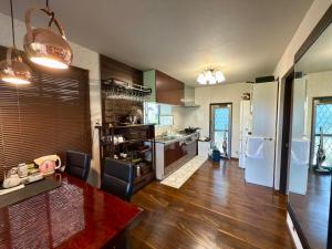a kitchen with a table and a dining room at House KIMIJIMA in Yachimata