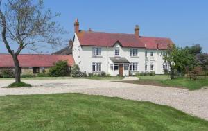 a large white house with a red roof at Lowerfield Farm in Broadway