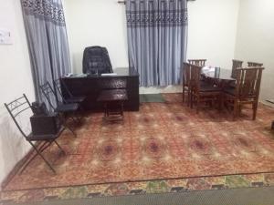 a room with a piano and a table and chairs at Bhaderwah Valley Resort in Bhadarwāh