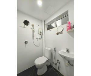 a bathroom with a shower and a toilet and a sink at 61 StayAtHome in Nibung Tebal +26 photos
