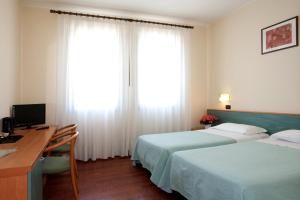 Postel nebo postele na pokoji v ubytování Hotel Valbrenta