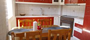 a kitchen with a table with chairs and a sink at "Alsos View" in Agrinio