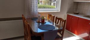 a kitchen with a table with chairs and a sink at "Alsos View" in Agrinio